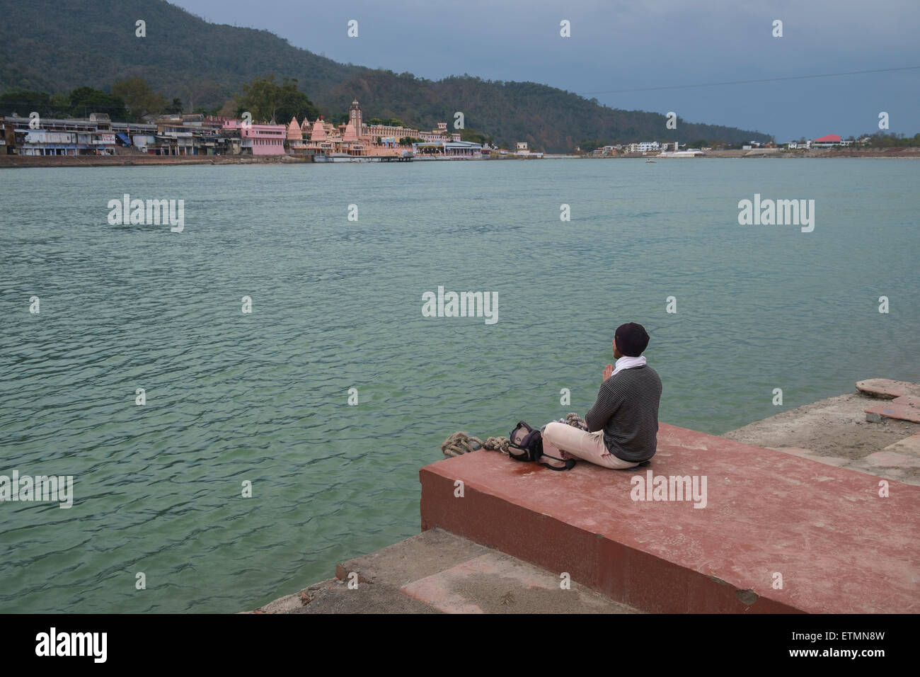 Man meditaing on the bank of river Ganges at Rishikesh, India. Stock Photo