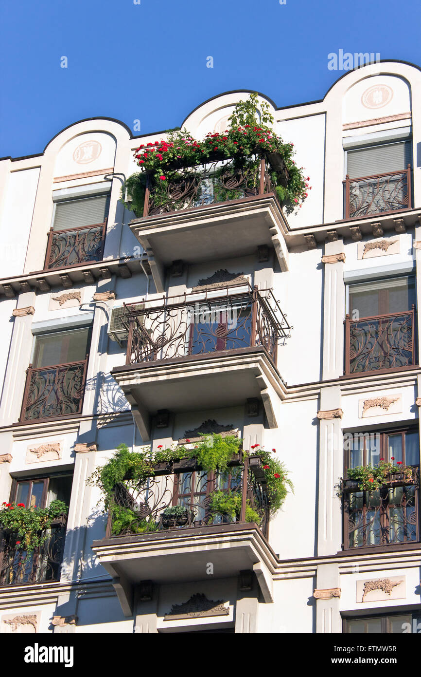 Old building with house plants on the balcony Stock Photo