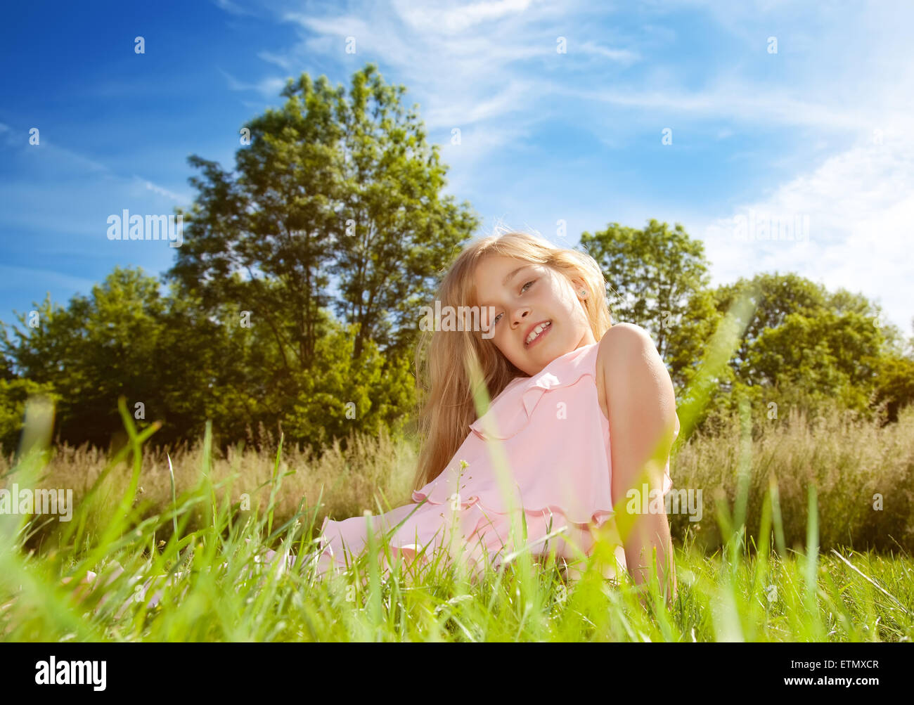 little girl sitting on green grass Stock Photo - Alamy