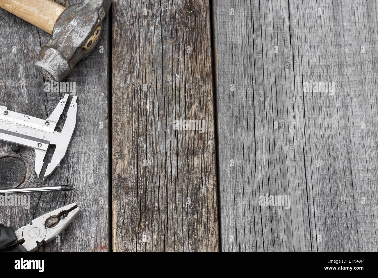 Different construction tools on a wooden background with copy space ...