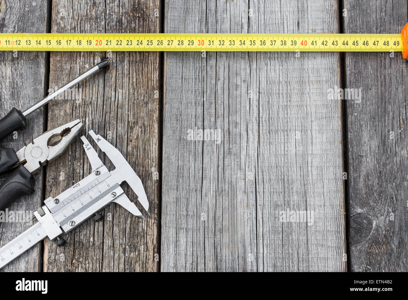 Different construction equipment on a wooden background with copy space ...