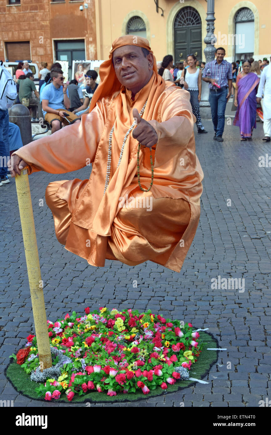 A busker in an orange robe appears to levitate in exchange for ...