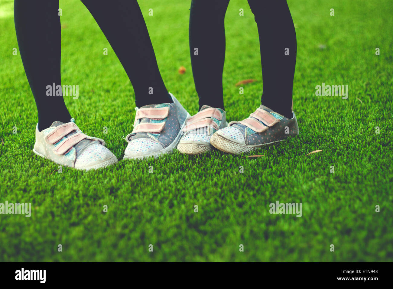 Low section of two girls wearing sneakers Stock Photo