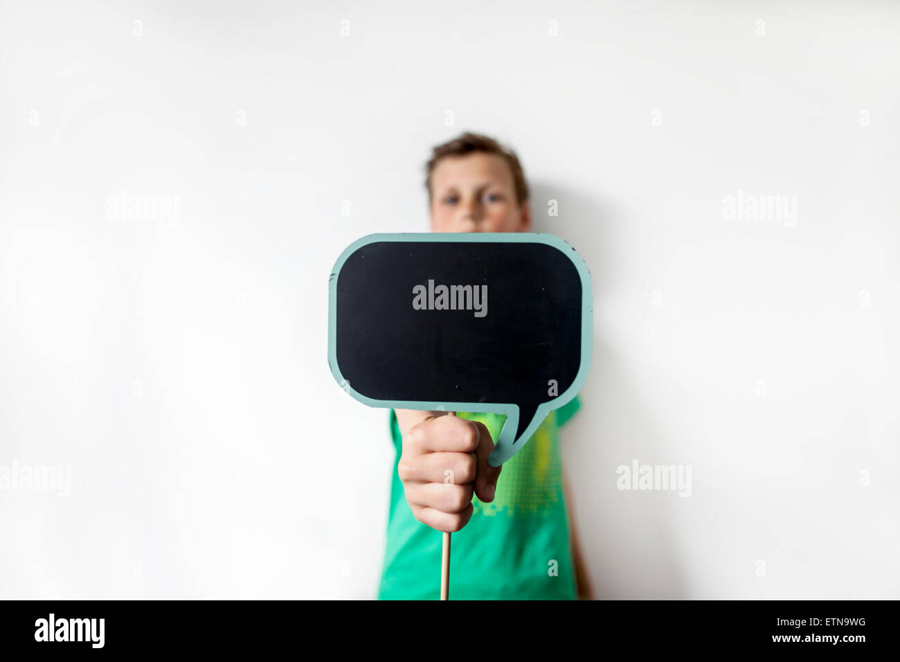 Close up of a boy holding a thought bubble board Stock Photo