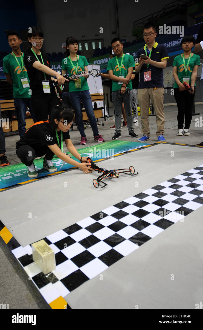 Beijing, China. 15th June, 2015. Competitors put their elastic model car at the start during the competition in Beijing, capital of China, June 15, 2015. The 2015 Formula-E China Design Championship was held at Beijing University of Technology on Monday. Thirty-five teams from fourteen universities in China competed for the opportunity to attend the global final held in Los Angeles in August. Credit:  Liu Yongzhen/Xinhua/Alamy Live News Stock Photo