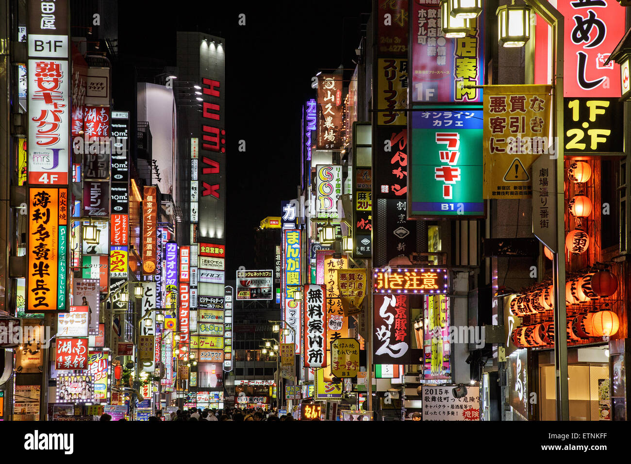 Neons and bright lights in one of streets of Kabukicho entertainment and red light district at night in Shinjuku, Tokyo, Japan Stock Photo