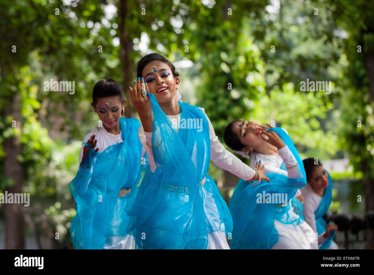 Dhaka, Bangladesh. 15th June, 2015. Bengali people celebrate Borsha utsab 1422 (Rainy season festival) at Bangla academy, arrange by Udichi Shilpi Gosthi in Dhaka. Borsha Festival is observed in the Bangla month of Ashar and Srabon that compromises the rainy season (Borsha). In this month, the nature talks in rain as if it's her only language. During this season, low lands are flooded and boat becomes the only way of transportation in those areas. Kadam flowers make a great effect in the romantic mind of the Bangle. Credit:  ZUMA Press, Inc./Alamy Live News Stock Photo