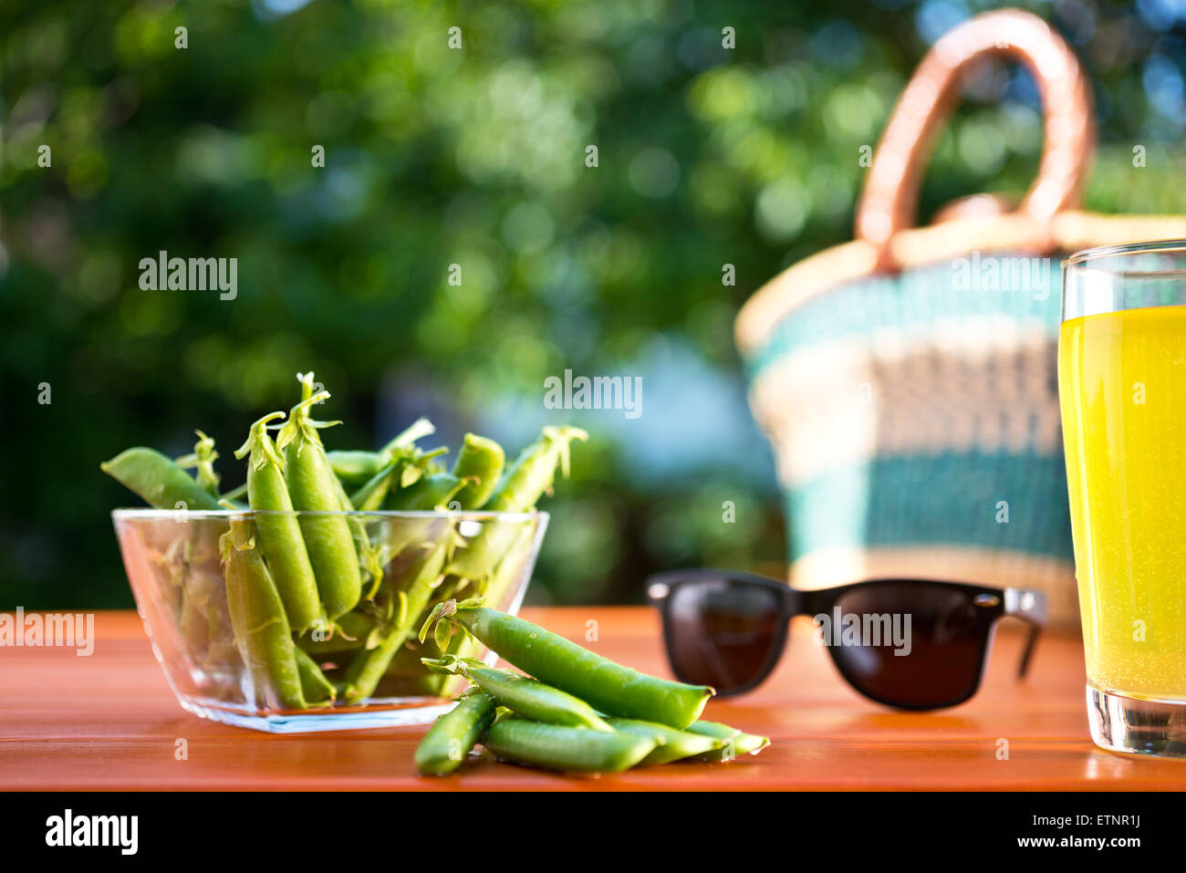 green peas with shopping basket on the desk in the garden Stock Photo