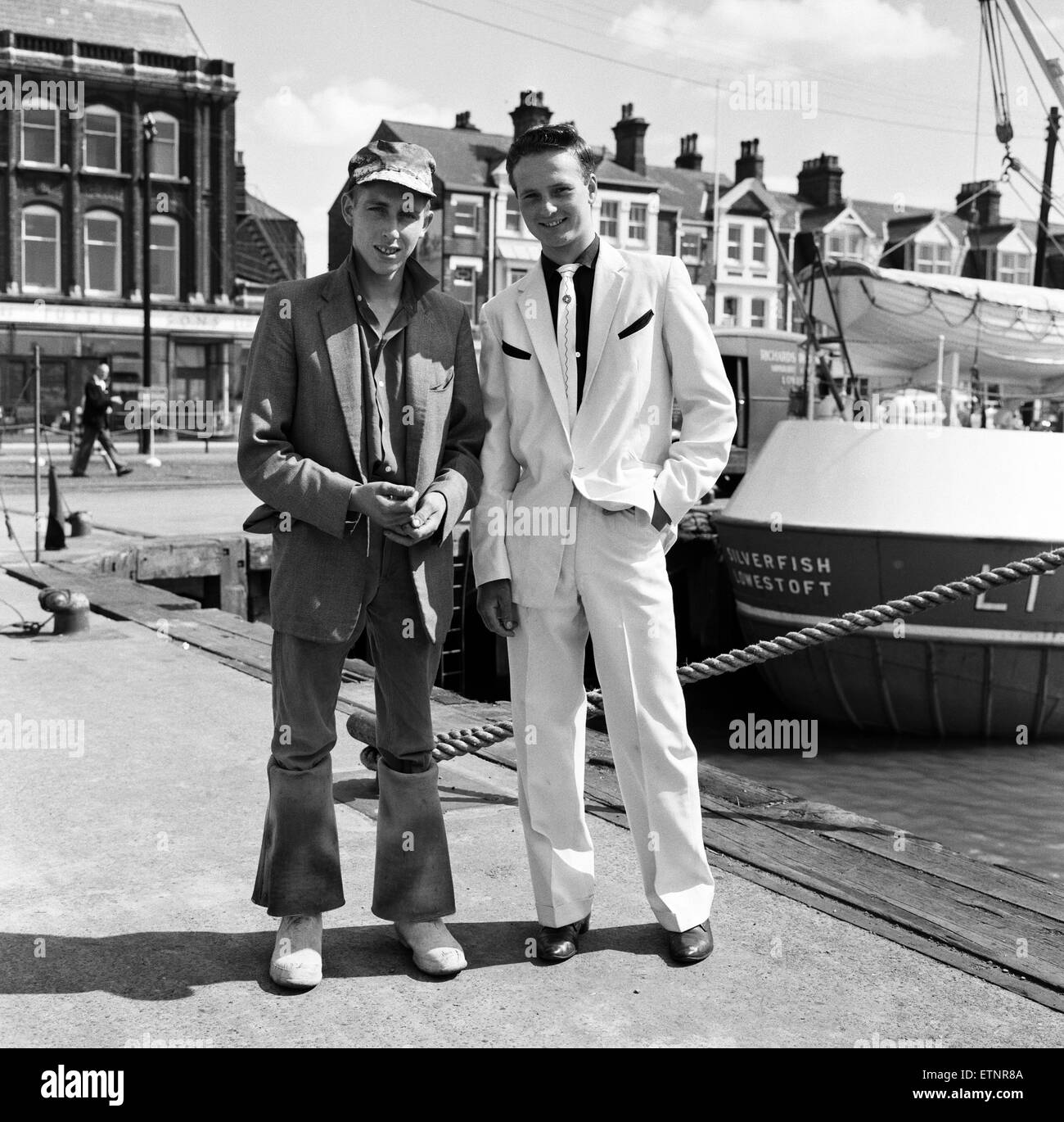 A new craze - Fancy suits worn by trawler fishermen at Lowestoft, Suffolk. Nigel Blowers, 18, who is about to go to sea, talking to friend Hylton Brighty, 16. 19th July 1961. Stock Photo
