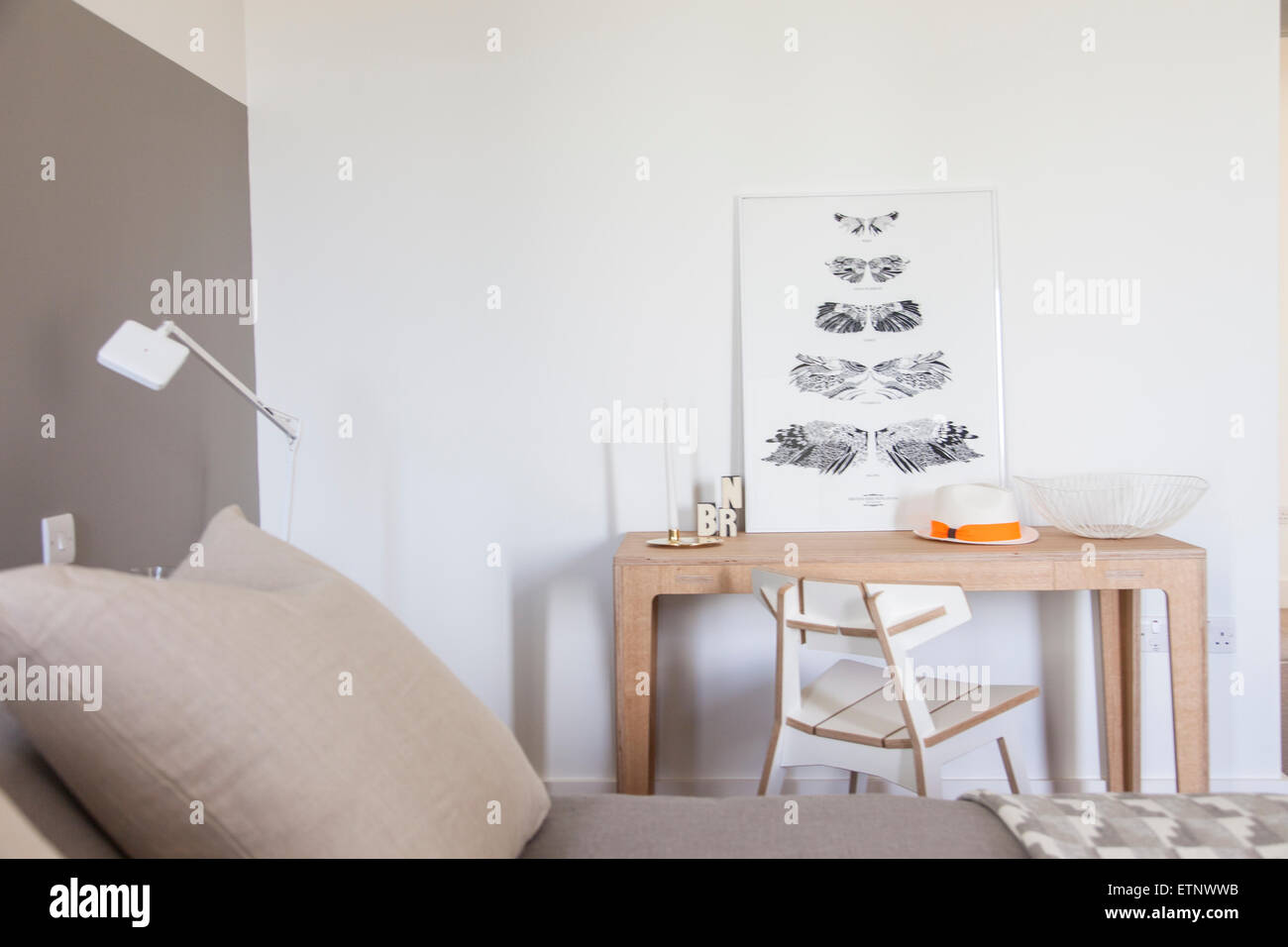 A modern desk and chair alongside the bed Stock Photo Alamy