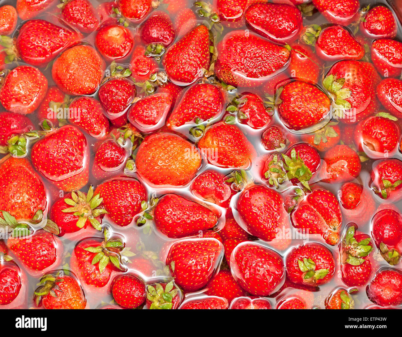 Ripe strawberries in water, nature background. Stock Photo
