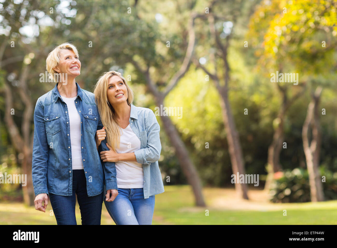 happy mother and daughter in the forest bird watching Stock Photo