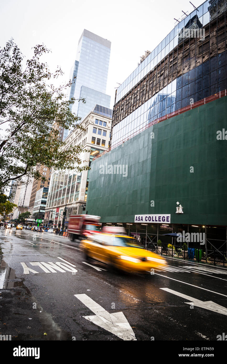 Abstract motion blur of a city street scene with a yellow taxi cabs ...