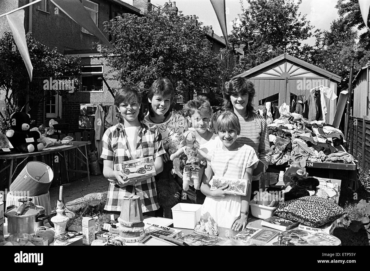 Showing some of the goods at a charity jumble sale on Saturday are (from left) Elizabeth Waite, Janine Brown, Catherine McAleese and Lisa and Tracey Moore.  The event, which also includes games and refreshments, was held in Larch Road, Paddock, at the home of Catherine and her sister, Helen.  The two youngsters and their friends hold the event annually.  This year, it was for the People's Dispensary for Sick Animals and proceeds amounted to £51.00.  10th August 1985. Stock Photo
