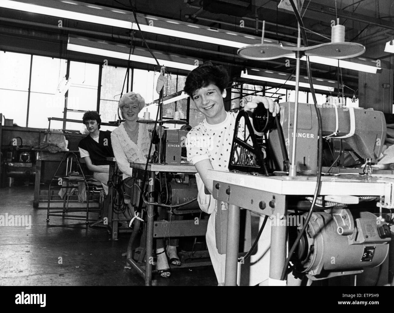 School leavers on the production line at Dannimac, Middlesbrough, where a further 30 new starters are being recruited at present at the rate of half-a-dozen a week. The girls pictured - Linda Brown (front), Allison Conway and Jacqueline Parry  - were taken on in August to work on a new production line and the rest of the newcomers will start a further new line. 10th November 1982. Stock Photo