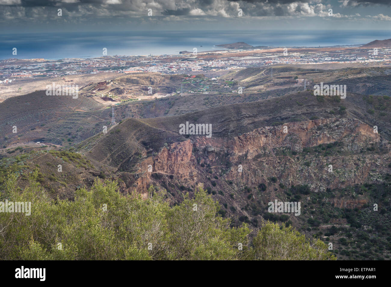 View from the volcanic cone of Pico de Bandama into the crater of the related Caldera de Bandama and over eastern Gran Canaria Stock Photo