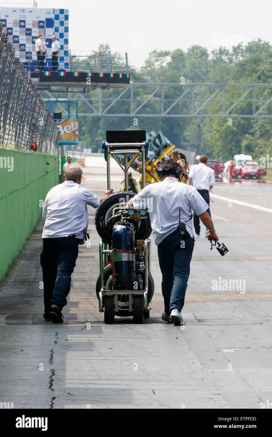 Monza, Italy - May 30, 2015: A man pushes a rack of tyres at the Autodromo Nazionale di Monza Circuit Stock Photo