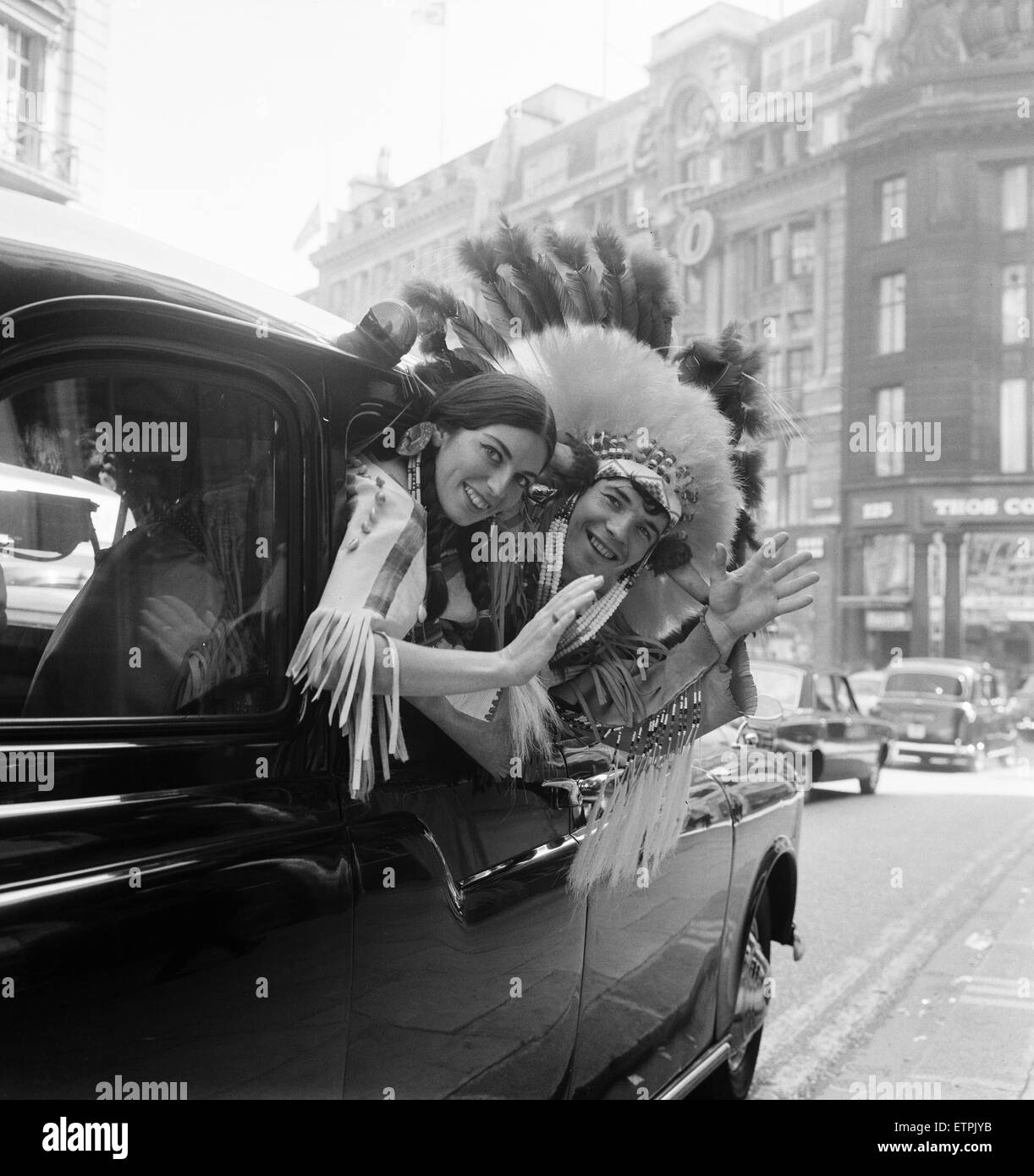 Couple of actors dressed as an Indian Chief and his Squaw, pictured leaving New Zealand House after press conference, 23rd September 1965. They are part of the Canadian National Folk Ensemble who are in the show Les Fux Follets at the Piccadilly Theatre. Stock Photo