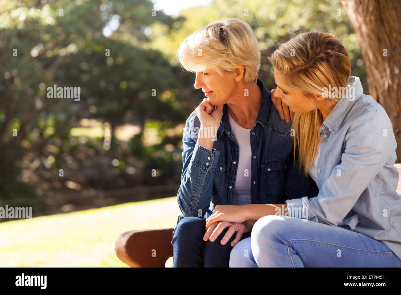 caring young daughter comforting senior mother Stock Photo - Alamy