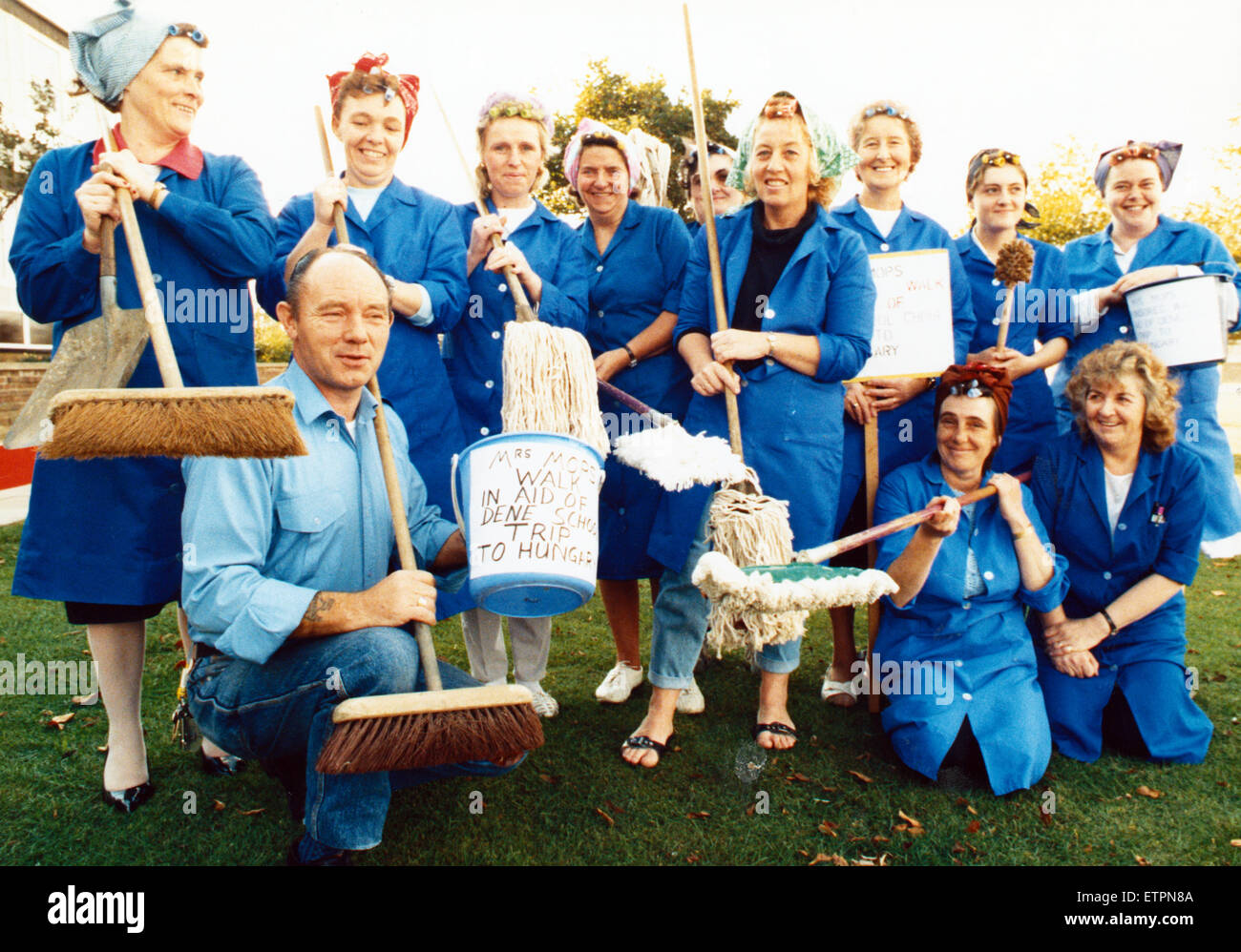 Cleaners from Dene School, Thornaby, were armed with their mops and brooms when they set off on the March of the Mops to raise money for the school choir Hungary fund. Seen with them is school caretaker Ken Brown. 12th October 1989. Stock Photo