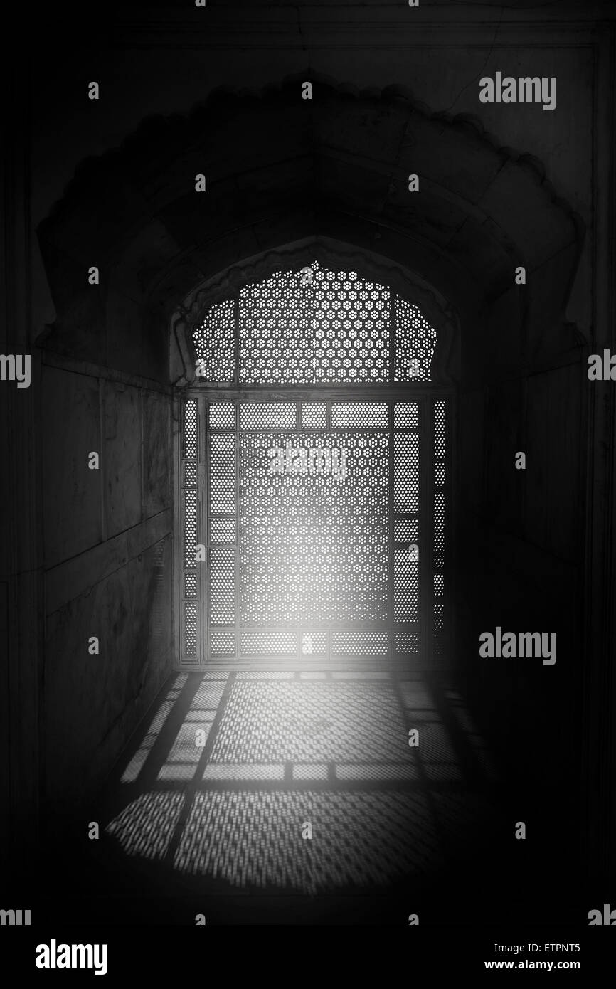 Light entering through carved Jaali screen placed on an arched window of a bedroom of Mughal Emperor Shah Jehan at Lahore Fort. Stock Photo