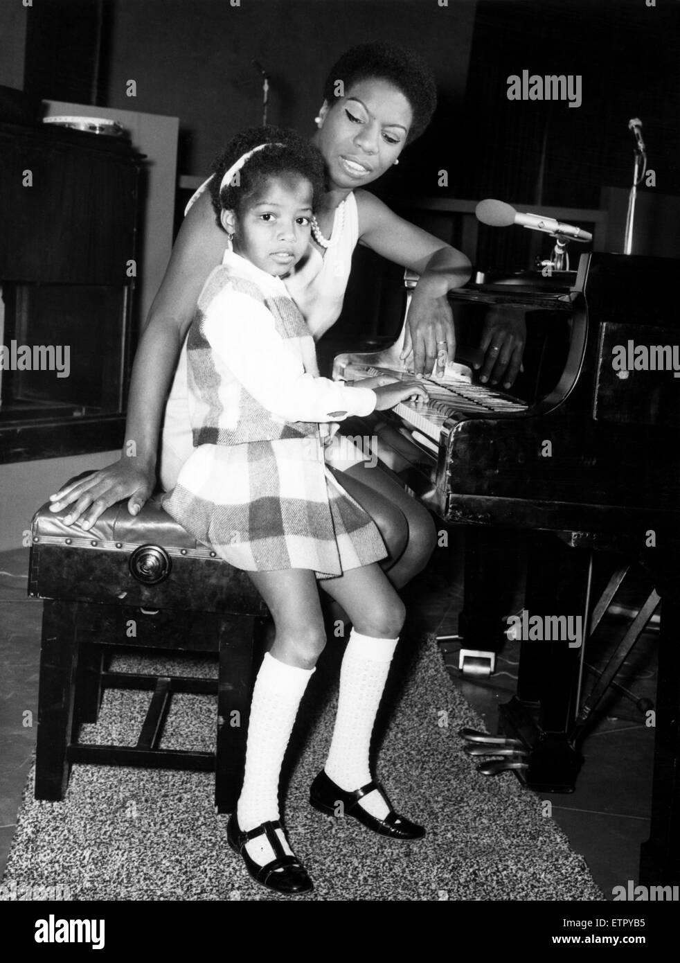 American singer, Nina Simone, in the UK recording a television programme called 'Sound of Soul' for London Weekend Television. Her 5 year old daughter Lisa loves to watch her mother at the studio, and already she is playing the piano. Wembley, London. 28t Stock Photo