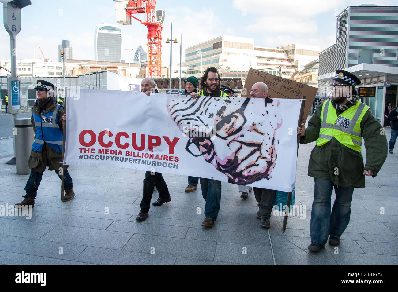 Occupy protesters gather outside the headquarters of News UK, owners of the Sun newspaper to hold an 'Occupy Rupert Murdoch' protest and hand out copies of 'The Occupied Sun.'  Featuring: View Where: London, United Kingdom When: 23 Mar 2015 Credit: Peter Maclaine/WENN.com Stock Photo