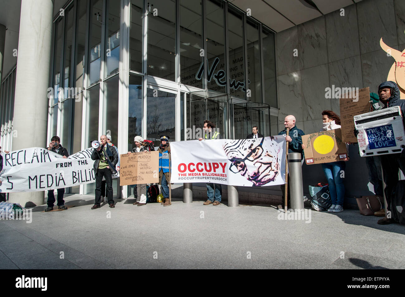 Occupy protesters gather outside the headquarters of News UK, owners of the Sun newspaper to hold an 'Occupy Rupert Murdoch' protest and hand out copies of 'The Occupied Sun.'  Featuring: View Where: London, United Kingdom When: 23 Mar 2015 Credit: Peter Maclaine/WENN.com Stock Photo