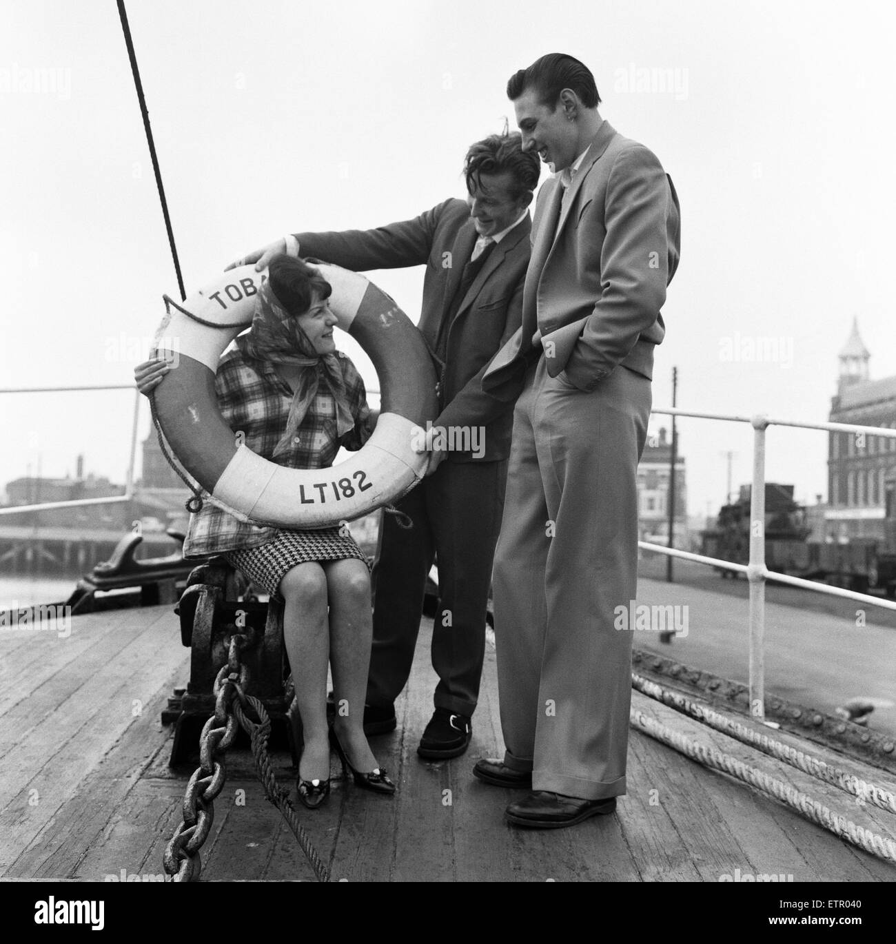 Ray Winney, 16, and Tony Scrivens, 16, with Gloria Knights, 17. on the boat 'Tobago'. 'Dockside Dandies' at Lowestoft, Suffolk. 16th May 1962. Stock Photo