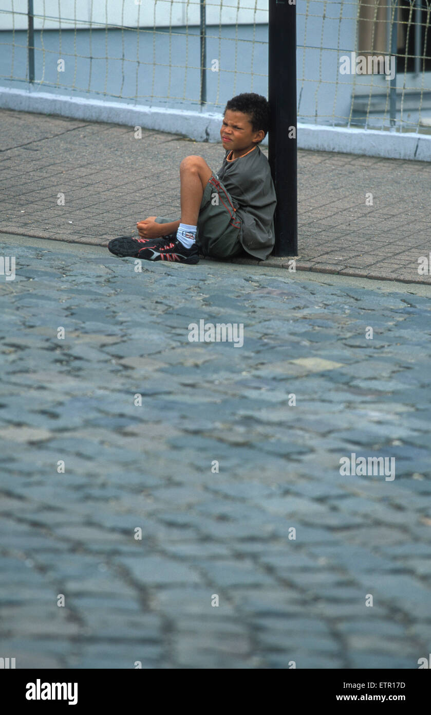 BEL, Belgium, Eastbelgium, Kelmis, Calamine, young boy sitting on the pavement.  BEL, Belgien, Ostbelgien, Kelmis, Calamine, Jun Stock Photo