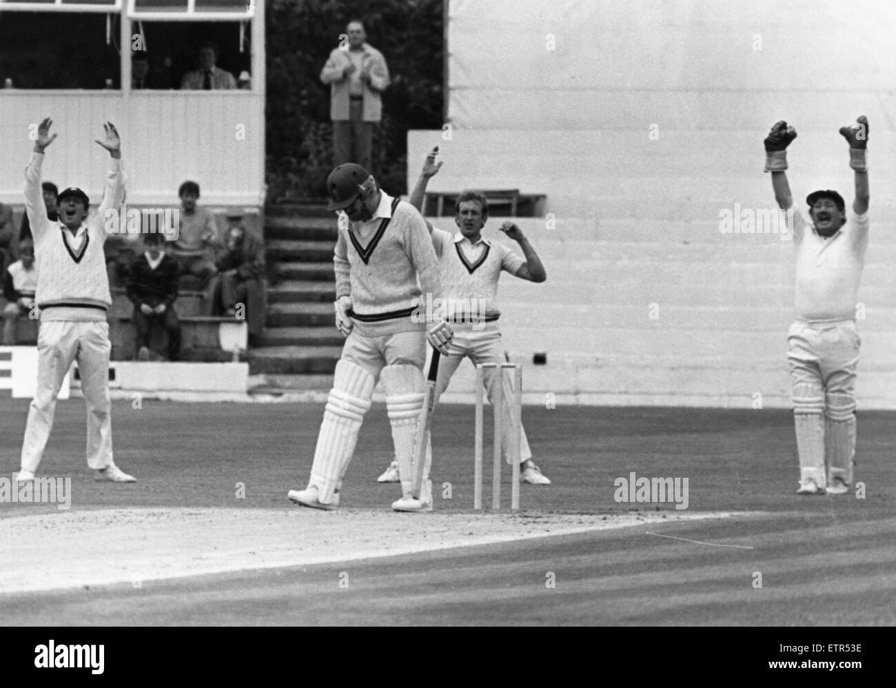 Howzat! Wayne Larkins, the Northants opener is unmoved by an unsuccessful appeal foe a catch by Yorkshire wicketkeeper David Bairstow and Bill Athey at Acklam Park. 19th June 1982 Stock Photo