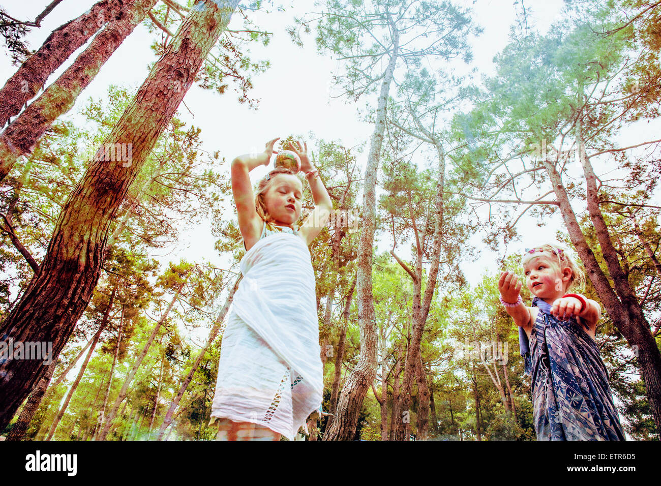 Two little girls play in a forsest Stock Photo - Alamy