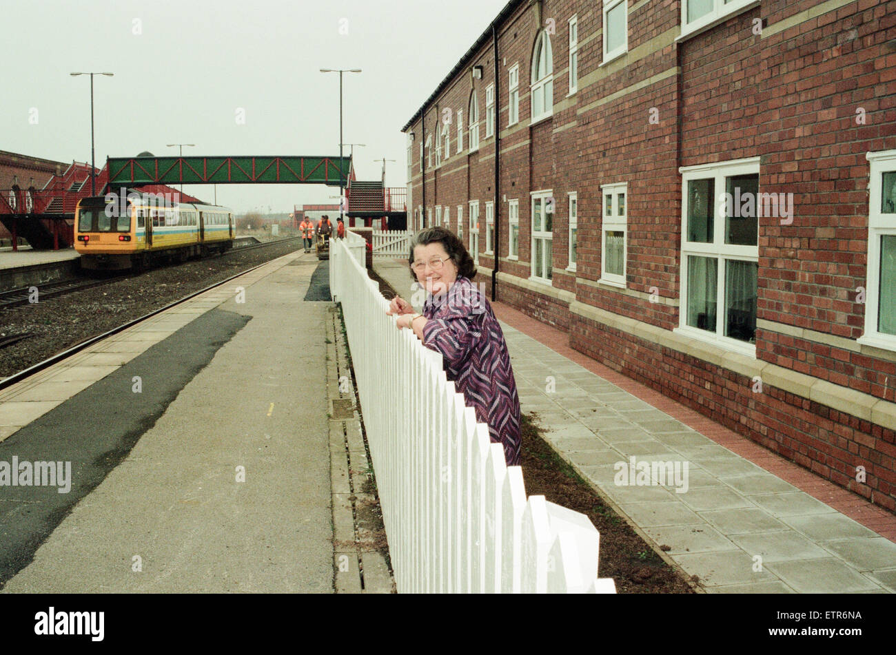 Stockton Railway Station, 1st December 1994. Watching the trains to go by, Joan Taylor, one of the residents in the Stockton Railway Station Housing Association Flats, watches the trains from the gardens near her flat. Stock Photo