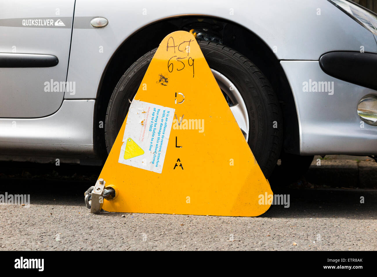 A wheel clamp fitted by the DVLA to a car whose keeper has not paid