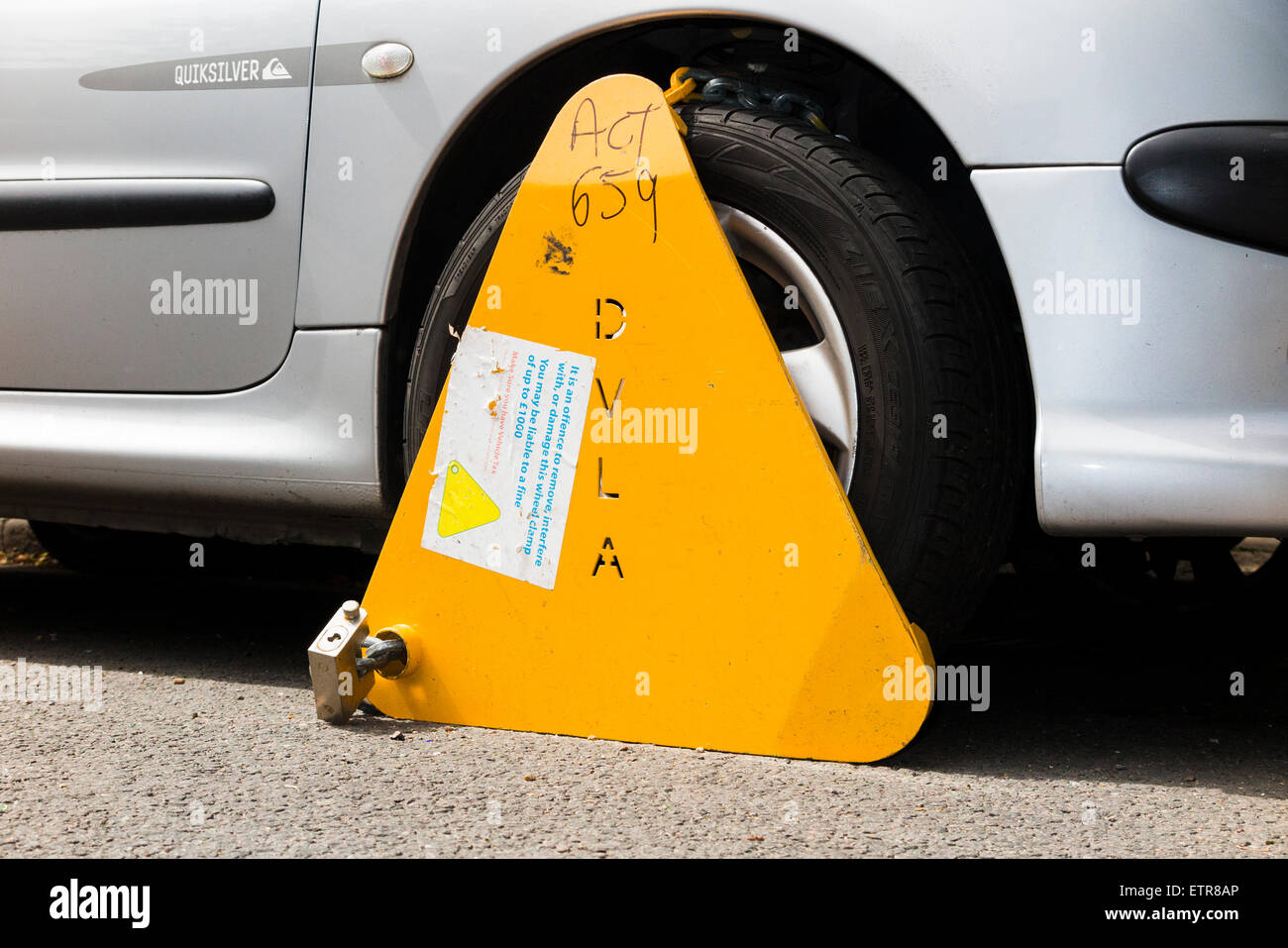 A wheel clamp fitted by the DVLA to a car whose keeper has not paid