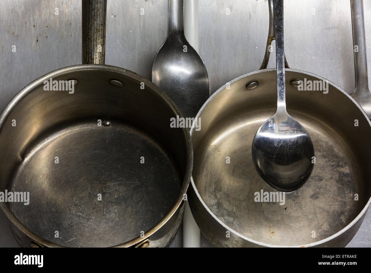 Cooking pans hanging in a chefs kitchen Stock Photo Alamy