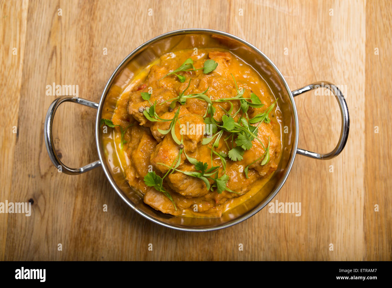 A metal balti bowl with chicken curry Stock Photo - Alamy