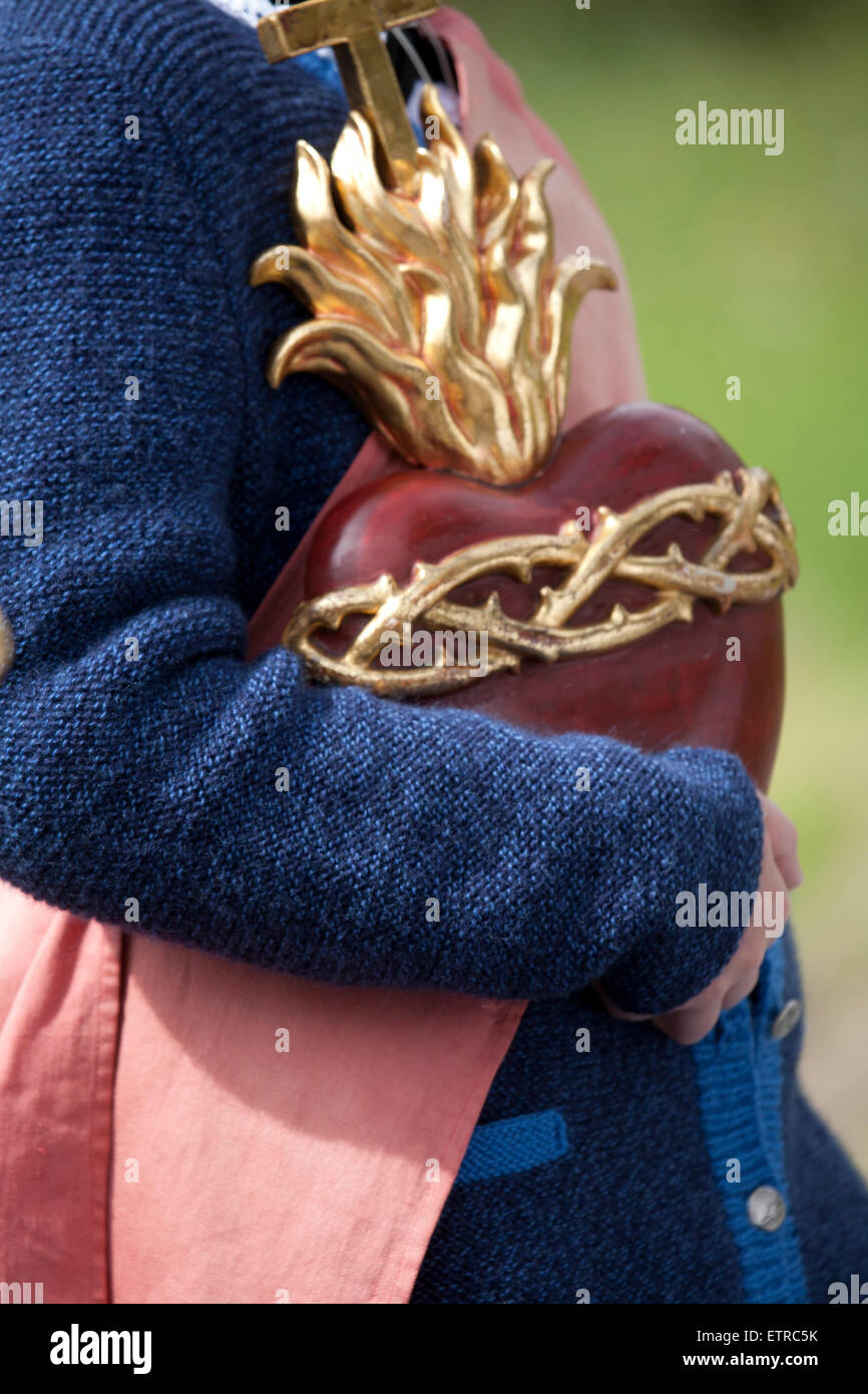 Traditionally dressed woman with a heart sculpture, Austria, Tyrol, Mutters Stock Photo