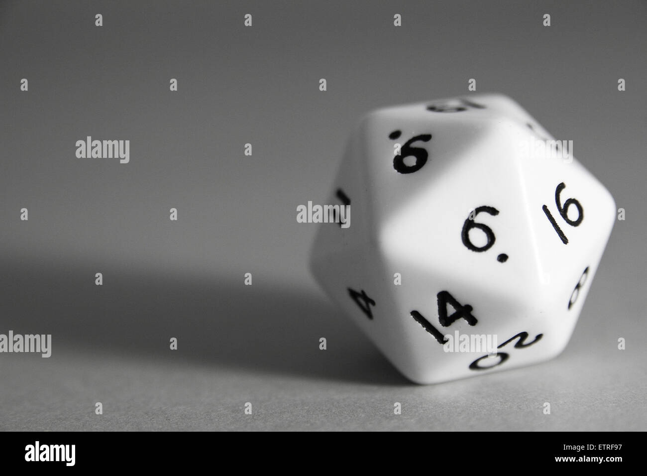 White marble Icosahedron dice on grey background Stock Photo