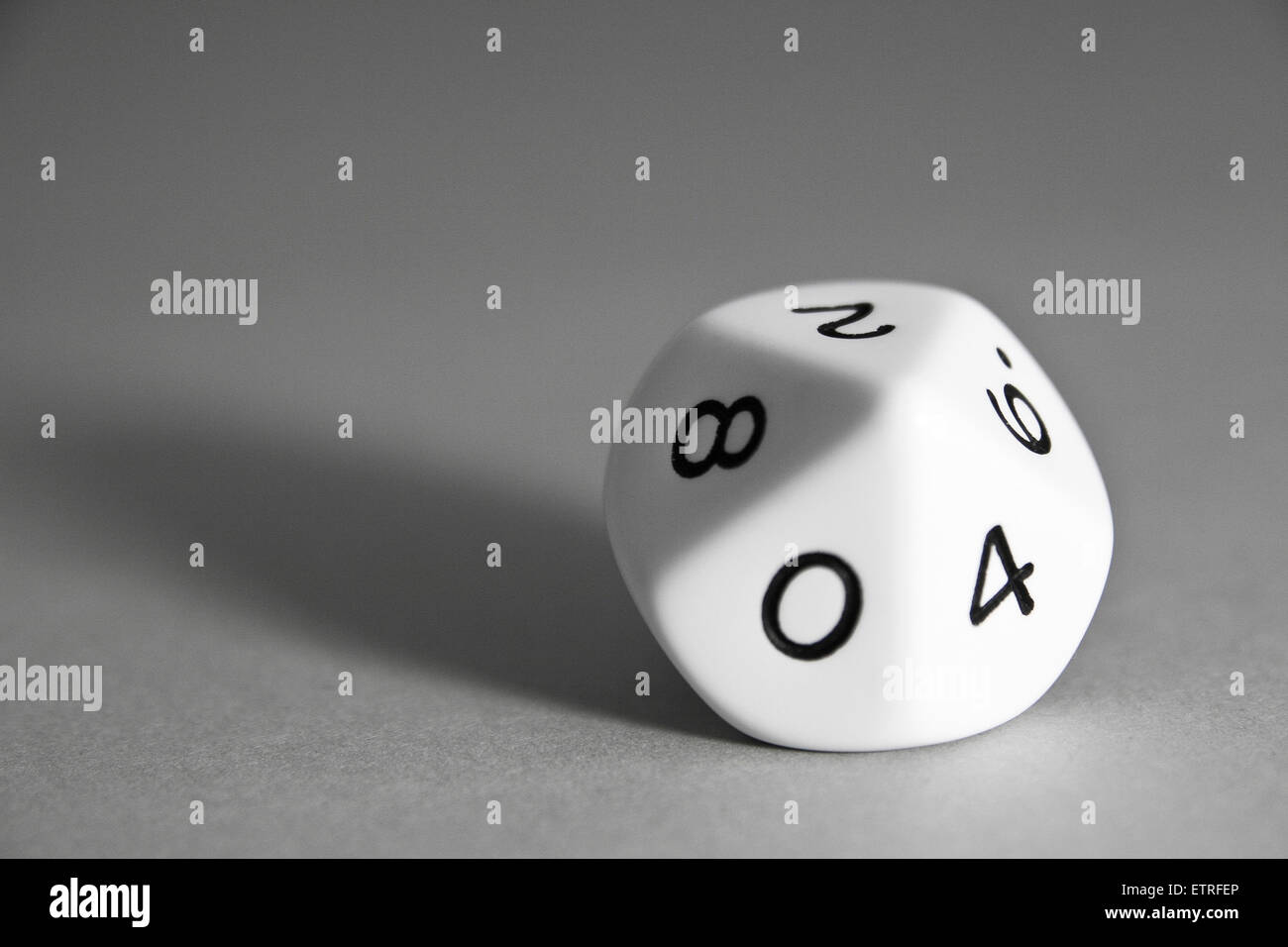 Pentagonal trapezohedron dice showing pair numbers side on grey background Stock Photo