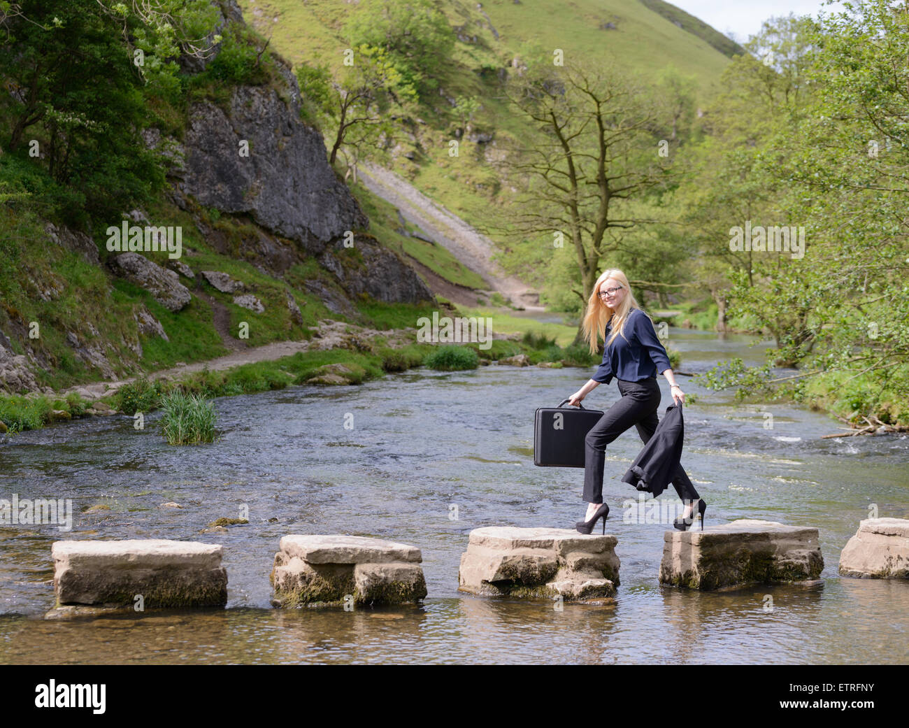 young business woman stepping stones to success metaphor Stock Photo