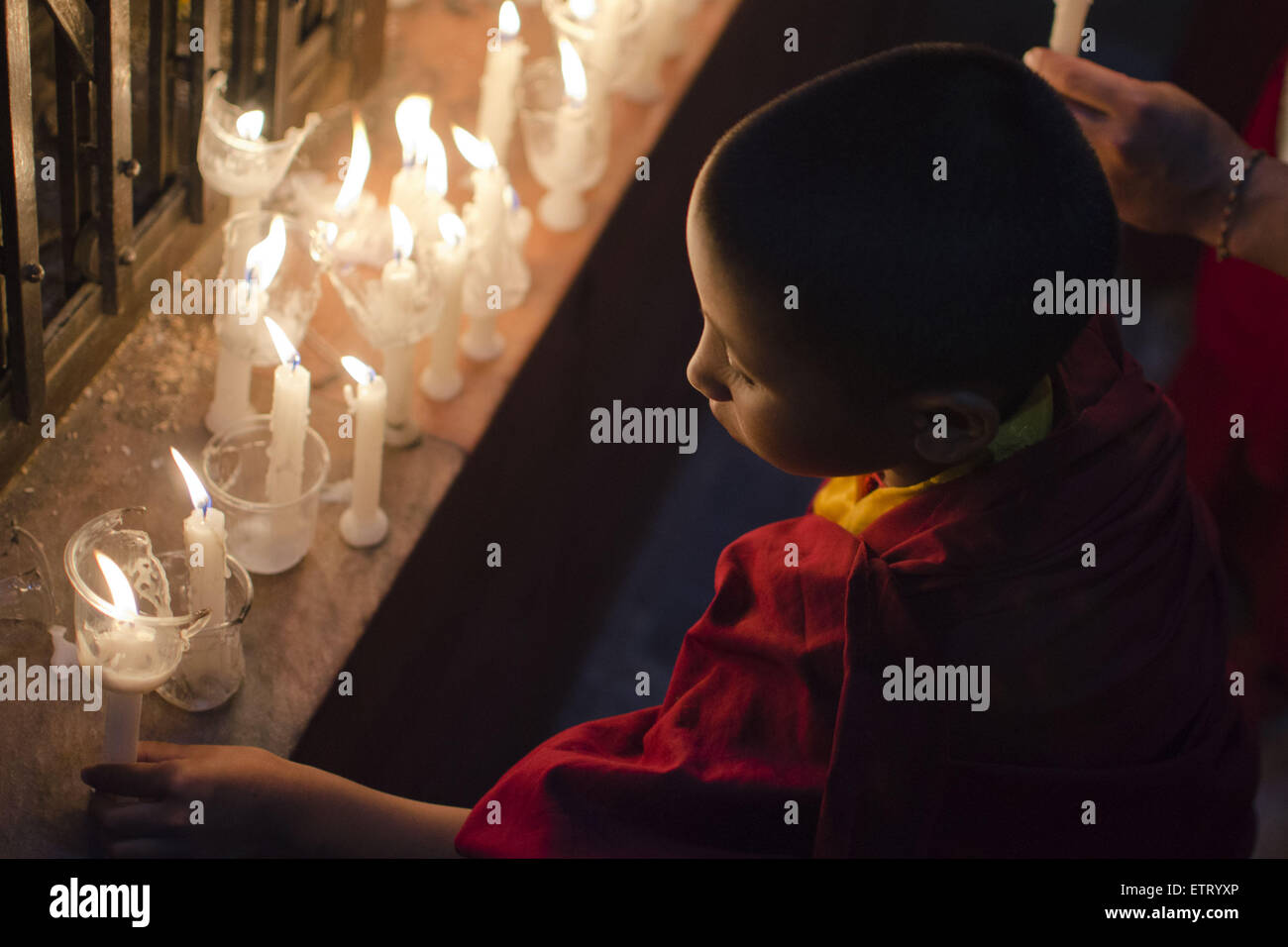 June 12, 2015 - Kathmandu, Nepal - A young Buddhist monk taking part in a mass gathering and candlelight vigil held at Boudhanath Stupa on 49th day after the April 25 earthquake in Kathmandu, Nepal. The massive earthquake which struck Nepal on April 25 and ensuing aftershocks have left nearly 9,000 people dead and destroyed or damaged tens of thousands of houses in Nepal. (Credit Image: © Sumit Shrestha/ZUMA Wire/ZUMAPRESS.com) Stock Photo