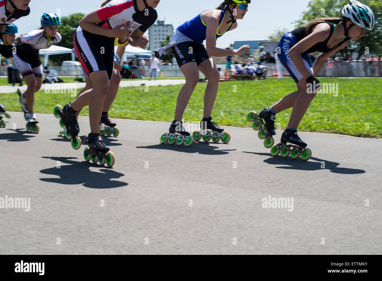Young in-line skaters in speed skates in motion during competitions Stock Photo