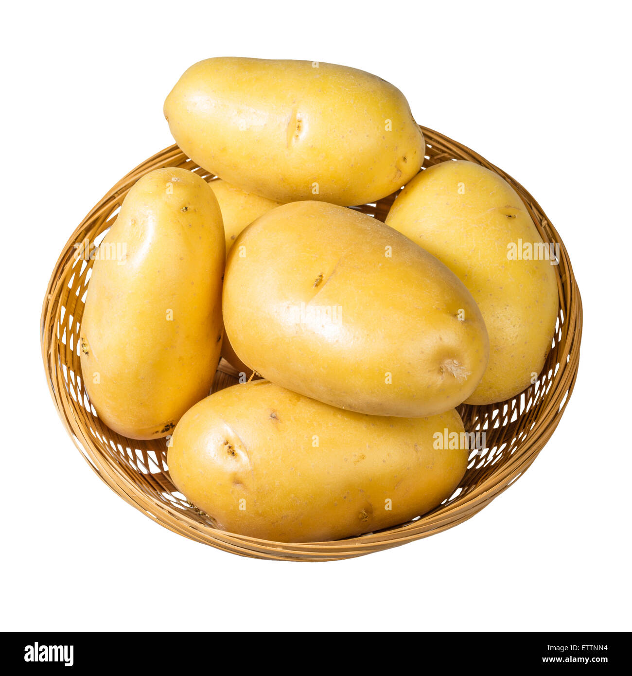 White potatoes fresh picked in wicker bowl isolated on white Stock Photo