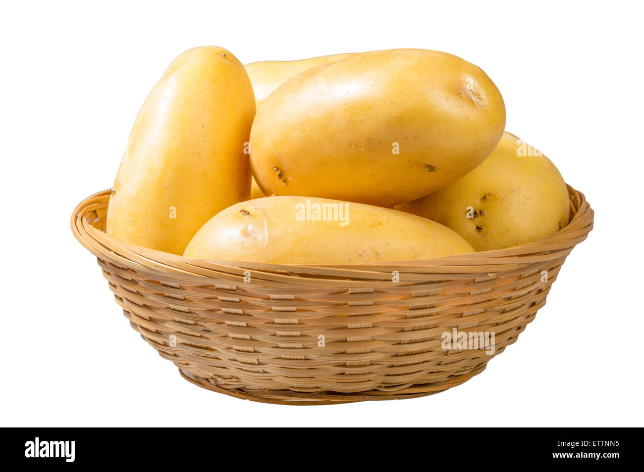 White potatoes fresh picked in wicker bowl isolated on white Stock Photo
