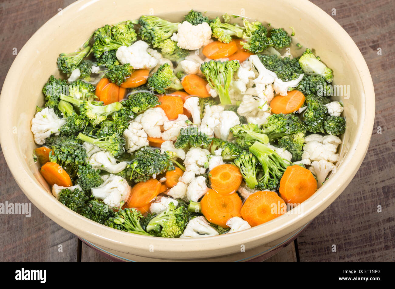 Bowl of fresh cut vegetables in brine for preserving Stock Photo