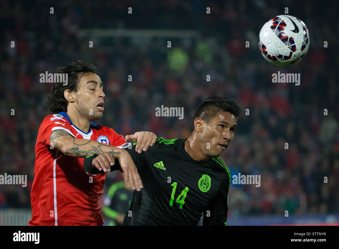 Santiago, Chile. 15th June, 2015. Jorge Valdivia (L) of Chile vies for the ball with Juan Valenzuela of Mexico during the the Group A match of the Copa America 2015, at the National Stadium, in Santiago, Chile, on June 15, 2015. The match ended with a 3-3 draw. Credit:  Pedro Mera/Xinhua/Alamy Live News Stock Photo