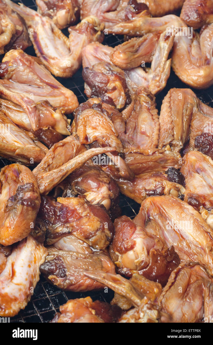 Raw honey chicken wings on BBQ grill Stock Photo