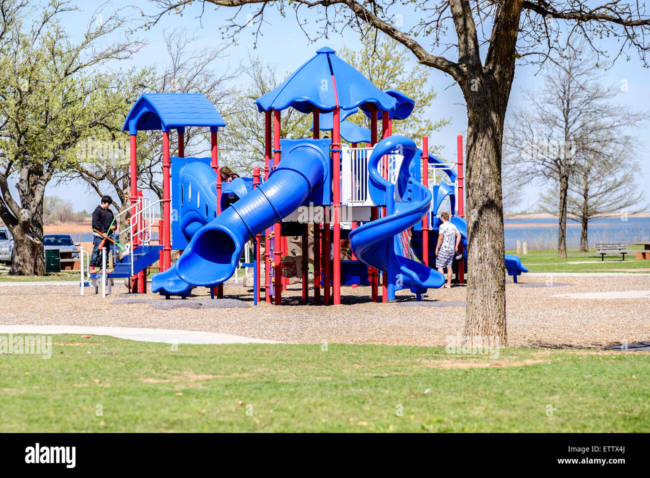 Two young men near a playground set in a public park, lakeside, in Oklahoma City, Oklahoma, USA. Stars and Stripes Park. Stock Photo