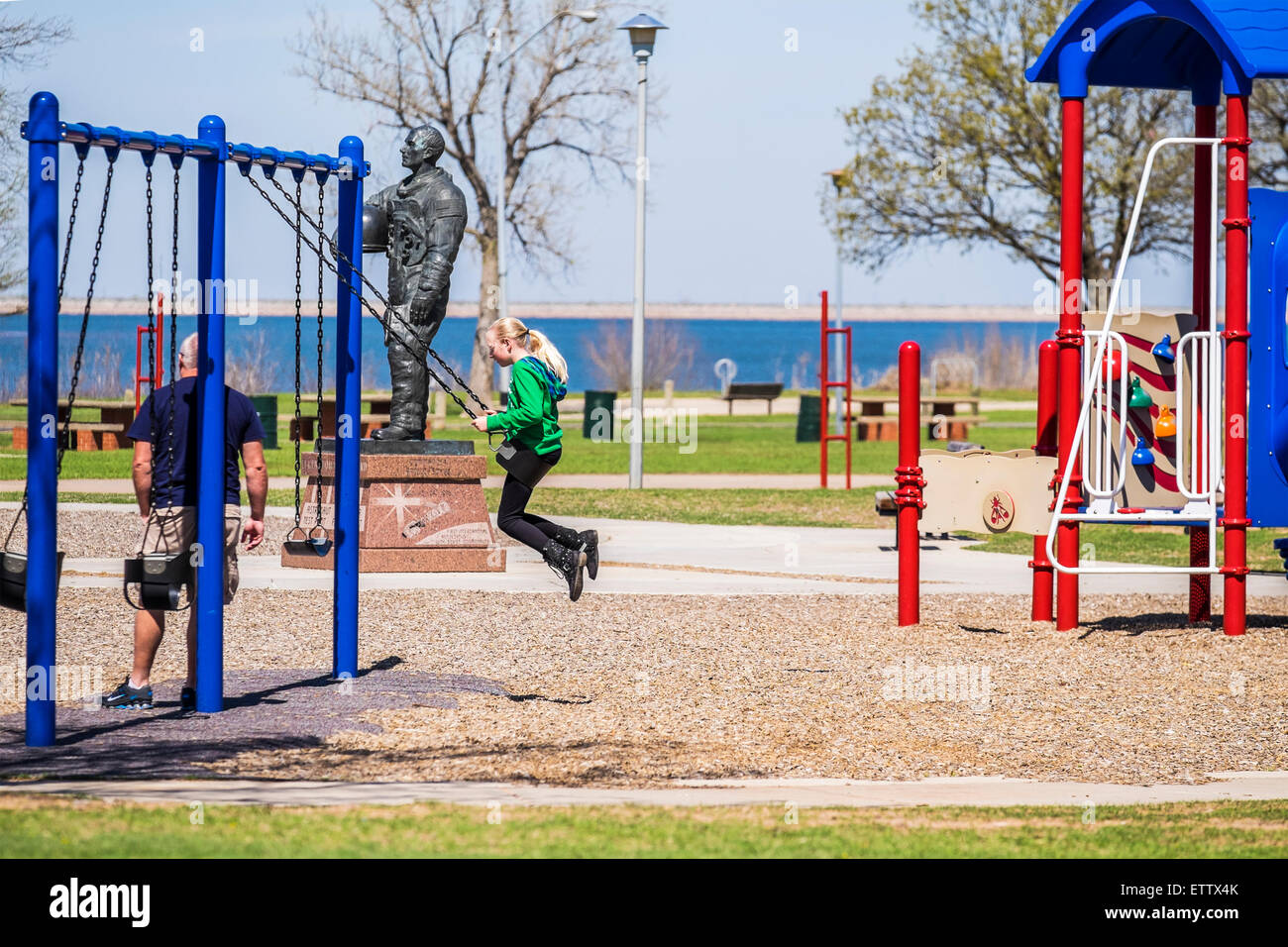 A Caucasian father and daughter enjoy the playground equipment at a public park in Oklahoma City, Oklahoma, USA. Stock Photo